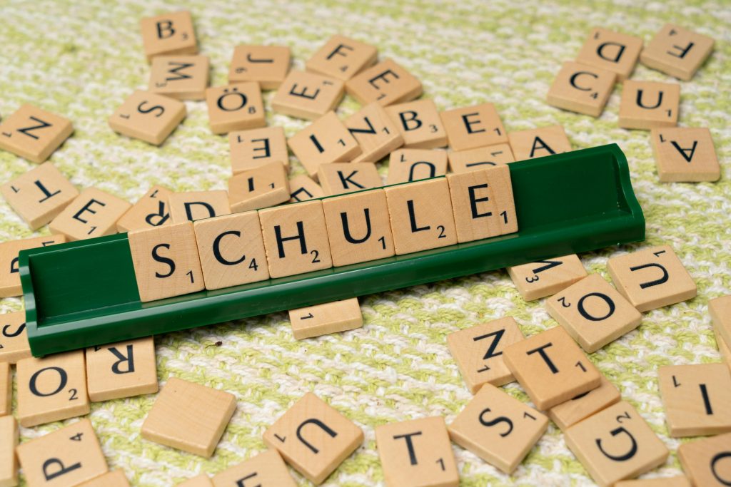 pexels photo 18512802 18512802 Word tiles spelling 'Schule' on table, ideal for language learning concepts.